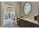 Hallway vanity area features marble countertop with sink and oval window, leading into main bedroom at 2305 Braselton Hwy, Buford, GA 30519