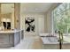 Bright bathroom with a large window overlooking a forest, and free standing tub at 2305 Braselton Hwy, Buford, GA 30519