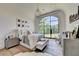 Bright bedroom with large window overlooking green landscape and decorative chandelier at 2305 Braselton Hwy, Buford, GA 30519