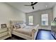 Bedroom with plush upholstered bed, side tables, hardwood floors, and sun-filled windows at 2305 Braselton Hwy, Buford, GA 30519
