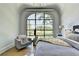 Bedroom featuring a cozy chair and a large arch window with outdoor views at 2305 Braselton Hwy, Buford, GA 30519