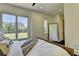 Serene bedroom boasts large windows, wood floors, and ample natural light with backyard views at 2305 Braselton Hwy, Buford, GA 30519