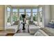 Bedroom sitting area with large windows providing stunning views of the lush, tree-filled backyard at 2305 Braselton Hwy, Buford, GA 30519