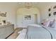 Bedroom with vaulted ceiling, grey walls and light wood floors, and neutral bedding at 2305 Braselton Hwy, Buford, GA 30519