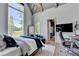 A modern bedroom with a geometric light fixture, desk, closet, and hardwood floors at 2305 Braselton Hwy, Buford, GA 30519