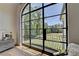 Bright bedroom with large arched window offering expansive views of the wooded yard at 2305 Braselton Hwy, Buford, GA 30519