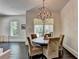 Bright dining area features a round table with seating, dark wood floors, and a modern orb chandelier at 2305 Braselton Hwy, Buford, GA 30519