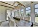 Bright dining room with a large wooden table, modern chandelier, and backyard views at 2305 Braselton Hwy, Buford, GA 30519