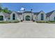 Beautiful white brick home with symmetrical design, black roof, and well-maintained landscaping at 2305 Braselton Hwy, Buford, GA 30519