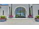 Elegant entrance features a striking arched glass door, stone steps, and decorative planters at 2305 Braselton Hwy, Buford, GA 30519