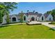 A well maintained lawn and driveway provide an inviting approach to the luxury home at 2305 Braselton Hwy, Buford, GA 30519