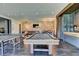 Recreation space features a pool table, ping pong table, brick wall, and stylish furnishings at 2305 Braselton Hwy, Buford, GA 30519