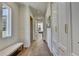 Hallway with shiplap walls, hardwood floors, storage cabinets, bench, and a glimpse into other rooms at 2305 Braselton Hwy, Buford, GA 30519