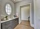 Hallway with an oval window, marble countertop with sink, patterned wallpaper, and an open doorway at 2305 Braselton Hwy, Buford, GA 30519