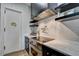 Kitchen with stainless steel oven, white countertops, floating shelves, and subway tile backsplash at 2305 Braselton Hwy, Buford, GA 30519
