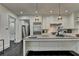Open concept kitchen with an island, stainless fridge and range at 2305 Braselton Hwy, Buford, GA 30519
