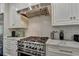 Stainless steel range in a kitchen with white cabinets and counters at 2305 Braselton Hwy, Buford, GA 30519
