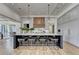 Modern kitchen island featuring bar stool seating and stylish pendant lighting at 2305 Braselton Hwy, Buford, GA 30519