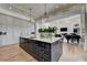 Gourmet kitchen featuring a large island, custom cabinets, and a view of the living room at 2305 Braselton Hwy, Buford, GA 30519