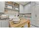 Laundry room featuring ample storage, a farmhouse sink, and a stylish tile floor at 2305 Braselton Hwy, Buford, GA 30519