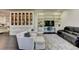 Spacious living room with custom built-ins, display cabinet, and comfortable seating area with sleek decor at 2305 Braselton Hwy, Buford, GA 30519