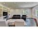 Living room with black couches, white chairs, and built in shelving at 2305 Braselton Hwy, Buford, GA 30519