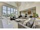 Bright living room featuring large windows, high ceilings, a chandelier, and comfortable seating arrangement at 2305 Braselton Hwy, Buford, GA 30519