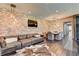 Spacious living room with brick wall, wood floors, and comfortable leather sofa at 2305 Braselton Hwy, Buford, GA 30519