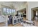 Open-concept living room with hardwood floors, high ceilings, and a view of the modern kitchen at 2305 Braselton Hwy, Buford, GA 30519