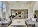 Open living space with grand piano, plush seating, and open view to the kitchen area at 2305 Braselton Hwy, Buford, GA 30519