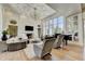 Bright living room with a fireplace, high ceilings, a piano and large windows at 2305 Braselton Hwy, Buford, GA 30519