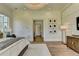 Main bedroom showcasing a modern chandelier, hardwood floors, ensuite entrance and a view of TV at 2305 Braselton Hwy, Buford, GA 30519