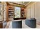 An elegant office with built-in bookshelves and a comfortable seating area at 2305 Braselton Hwy, Buford, GA 30519