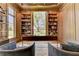 A well-lit office featuring built-in bookshelves and an executive desk at 2305 Braselton Hwy, Buford, GA 30519