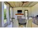 Relaxing screened-in outdoor dining area with a ceiling fan and an outdoor kitchen at 2305 Braselton Hwy, Buford, GA 30519