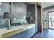 Wet bar featuring a marble countertop, brass accents and adjacent to the game room at 2305 Braselton Hwy, Buford, GA 30519
