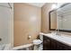 Bathroom with shower over tub, toilet, and sink with dark wood vanity at 3135 Reeves Se St, Smyrna, GA 30080