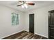 Bedroom with ceiling fan, new gray stained wood floors, and painted doors at 3135 Reeves Se St, Smyrna, GA 30080