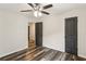 Bedroom with ceiling fan, new gray stained wood floors, and two doors at 3135 Reeves Se St, Smyrna, GA 30080