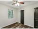 Bedroom with hardwood floors, overhead lighting, window, and a dark door at 3135 Reeves Se St, Smyrna, GA 30080