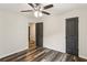 The bedroom features hardwood floors, an overhead fan, a window, and gray doors at 3135 Reeves Se St, Smyrna, GA 30080