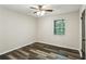 Clean bedroom with hardwood floors, overhead lighting, and a window at 3135 Reeves Se St, Smyrna, GA 30080
