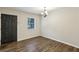 Living room with wood-look flooring, a window, and an entry door at 3135 Reeves Se St, Smyrna, GA 30080