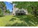 Expansive backyard with lush green grass and a deck overlooking the landscape at 3310 Chartwell Blvd, Suwanee, GA 30024