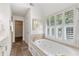 Bright bathroom includes a jacuzzi tub and plantation shutters at 3310 Chartwell Blvd, Suwanee, GA 30024