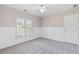 A bright bedroom with neutral walls, carpeted floor, and shuttered windows at 3310 Chartwell Blvd, Suwanee, GA 30024