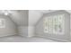 A bright bedroom with neutral walls, carpeted floor, and shuttered windows at 3310 Chartwell Blvd, Suwanee, GA 30024