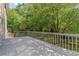 Exterior deck showcasing wood flooring and a backyard view surrounded by mature trees at 3310 Chartwell Blvd, Suwanee, GA 30024