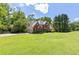 Beautiful two-story home showcasing its well-manicured lawn and mature trees at 3310 Chartwell Blvd, Suwanee, GA 30024