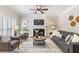 Comfortable living room with a fireplace, plush seating, and a ceiling fan at 3310 Chartwell Blvd, Suwanee, GA 30024